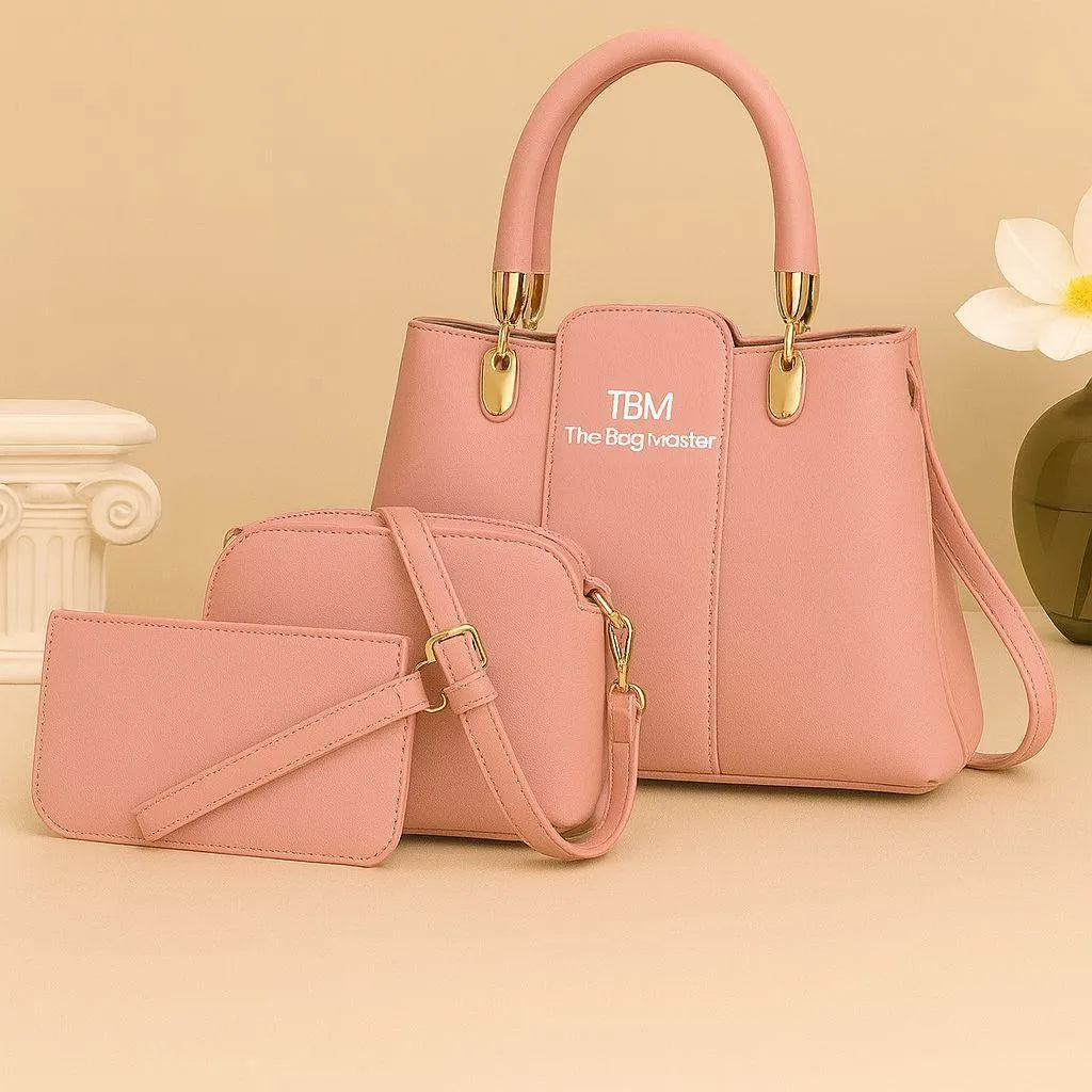 Pink handbag and matching pouch with 'TBM' logo on a beige background