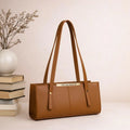 Brown handbag with 'The Bag Master' branding on a light background