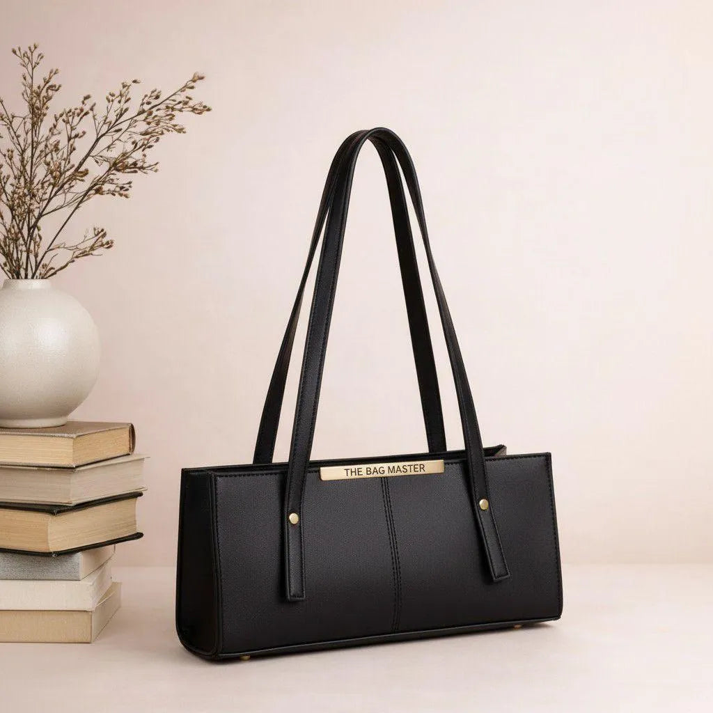 Black handbag with 'The Bag Master' branding on a light background