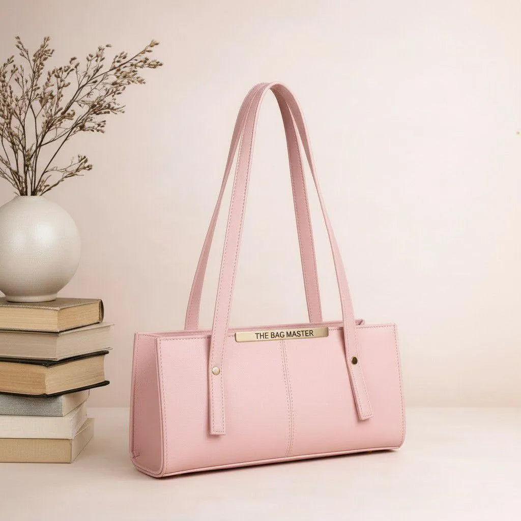 Pink handbag with 'The Bag Master' branding on a light background
