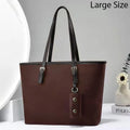 Brown handbag with black handles on a white background