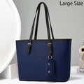 Blue handbag with black straps on a white background