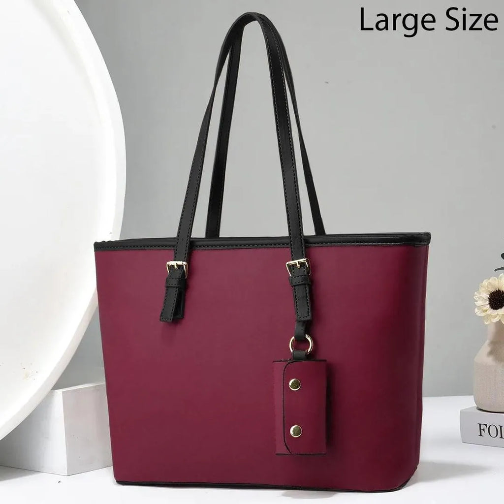 Maroon handbag with black straps on a white background