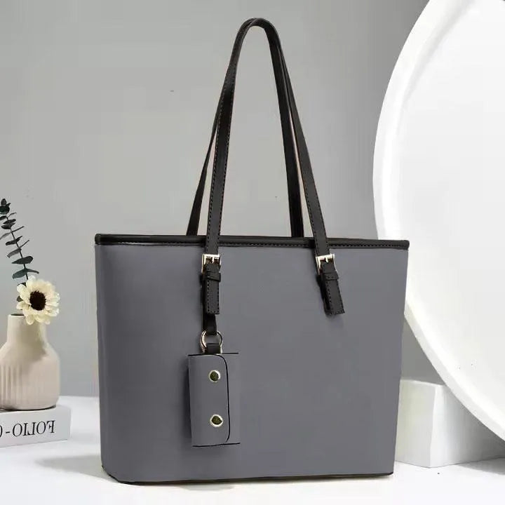 Gray tote bag with black handles on a light gray background