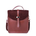 Brown leather backpack with a buckle on a white background